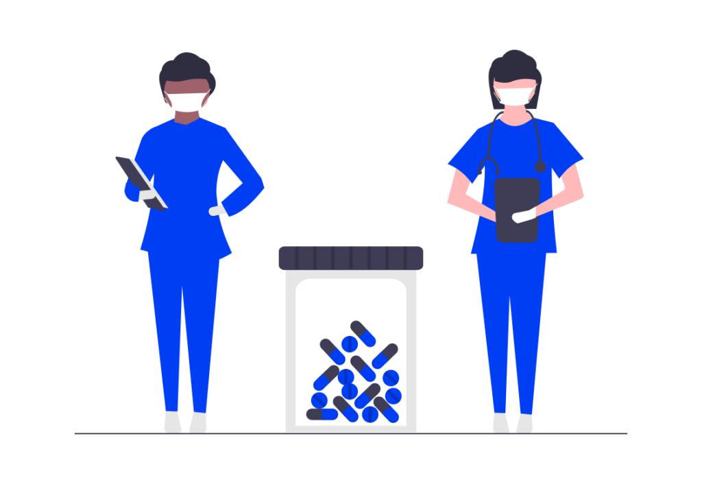 Two healthcare workers in blue uniforms and masks stand beside a container of pills, holding medical equipment.